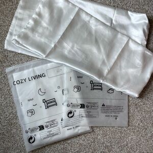 Two white satin pillowcases